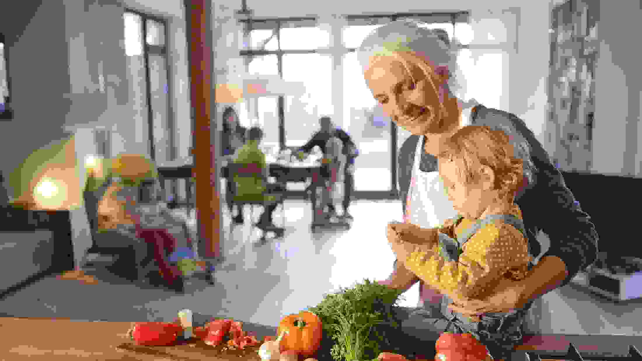 Grandmother with her grandchild preparing vegetables