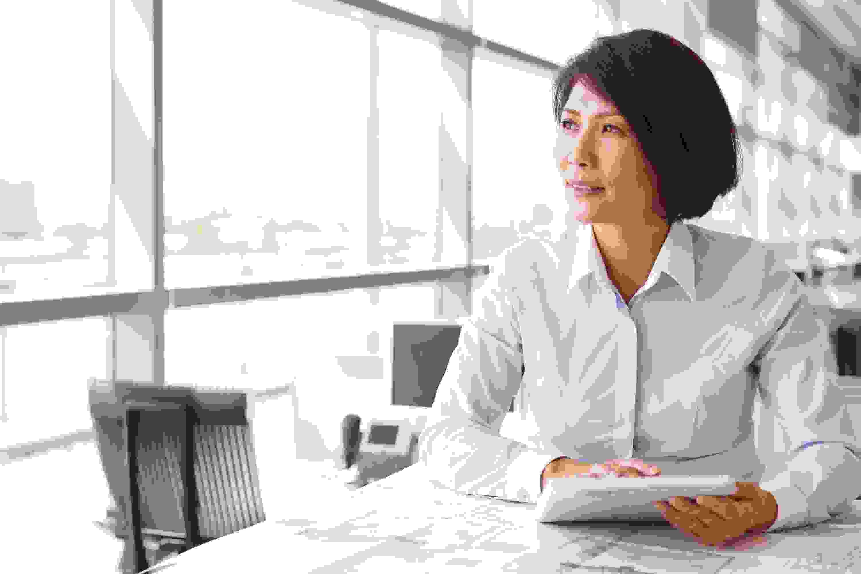 Women in office with architects plans | AXA Professional services insurance
