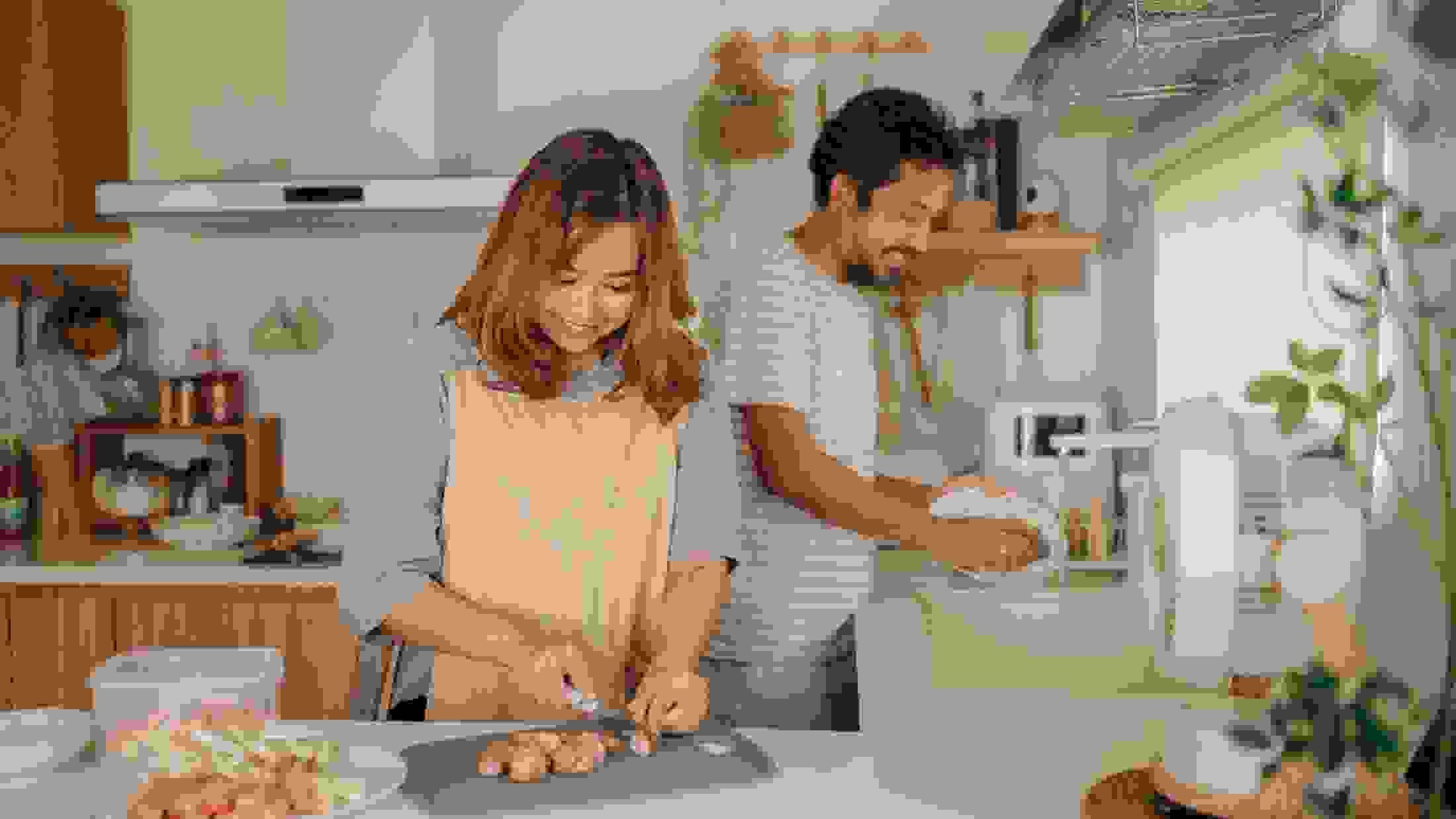 Happy affectionate couple talking while spending time in the kitchen