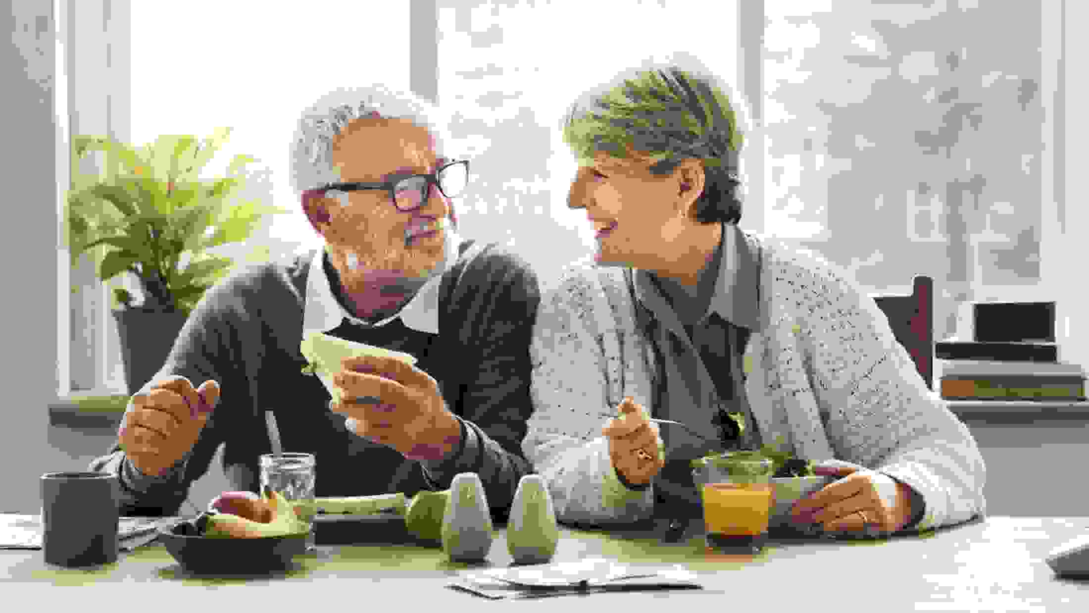 Senior couple having a breakfast in their kitchen