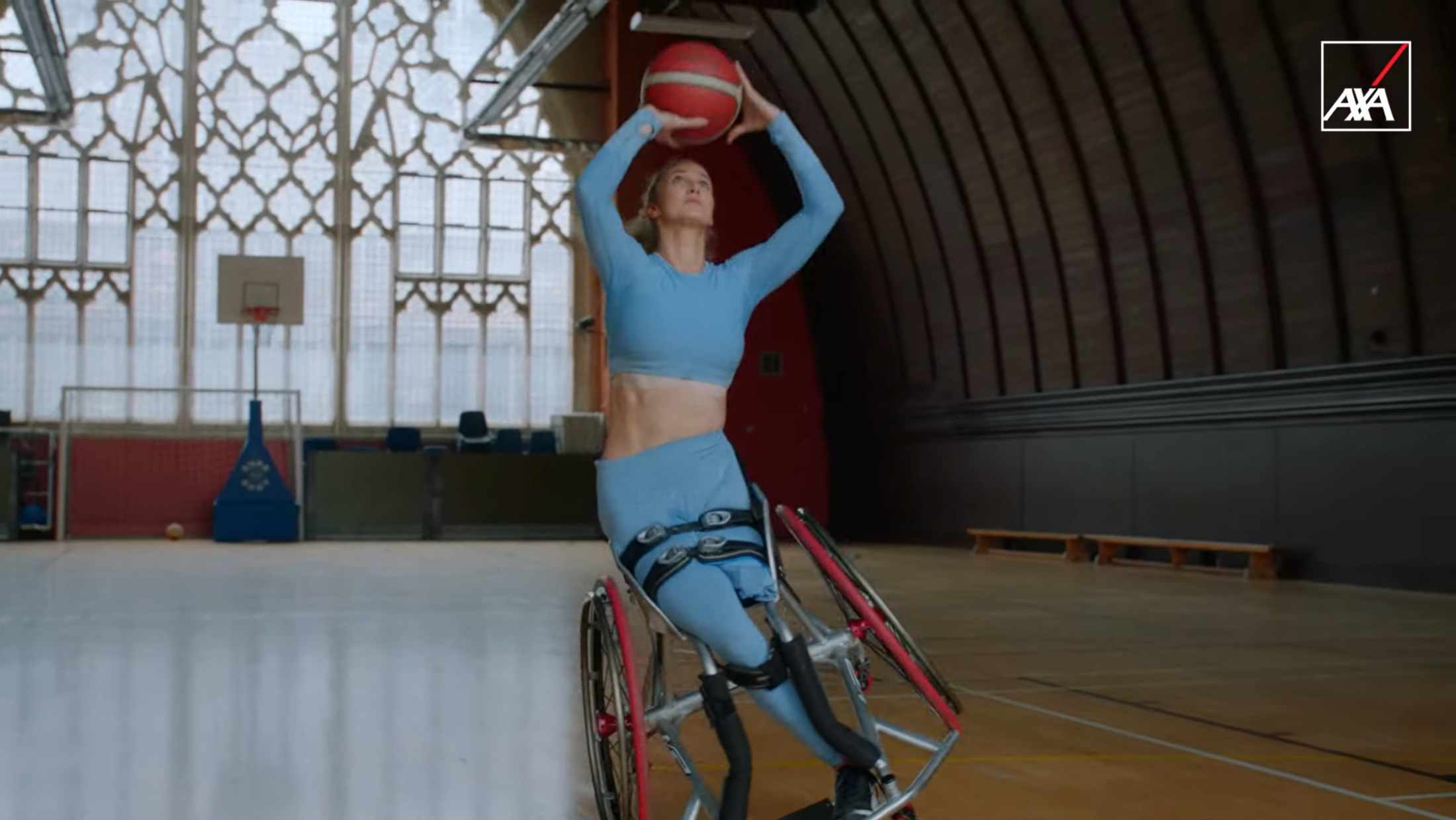Amy shooting a basketball on her wheelchair