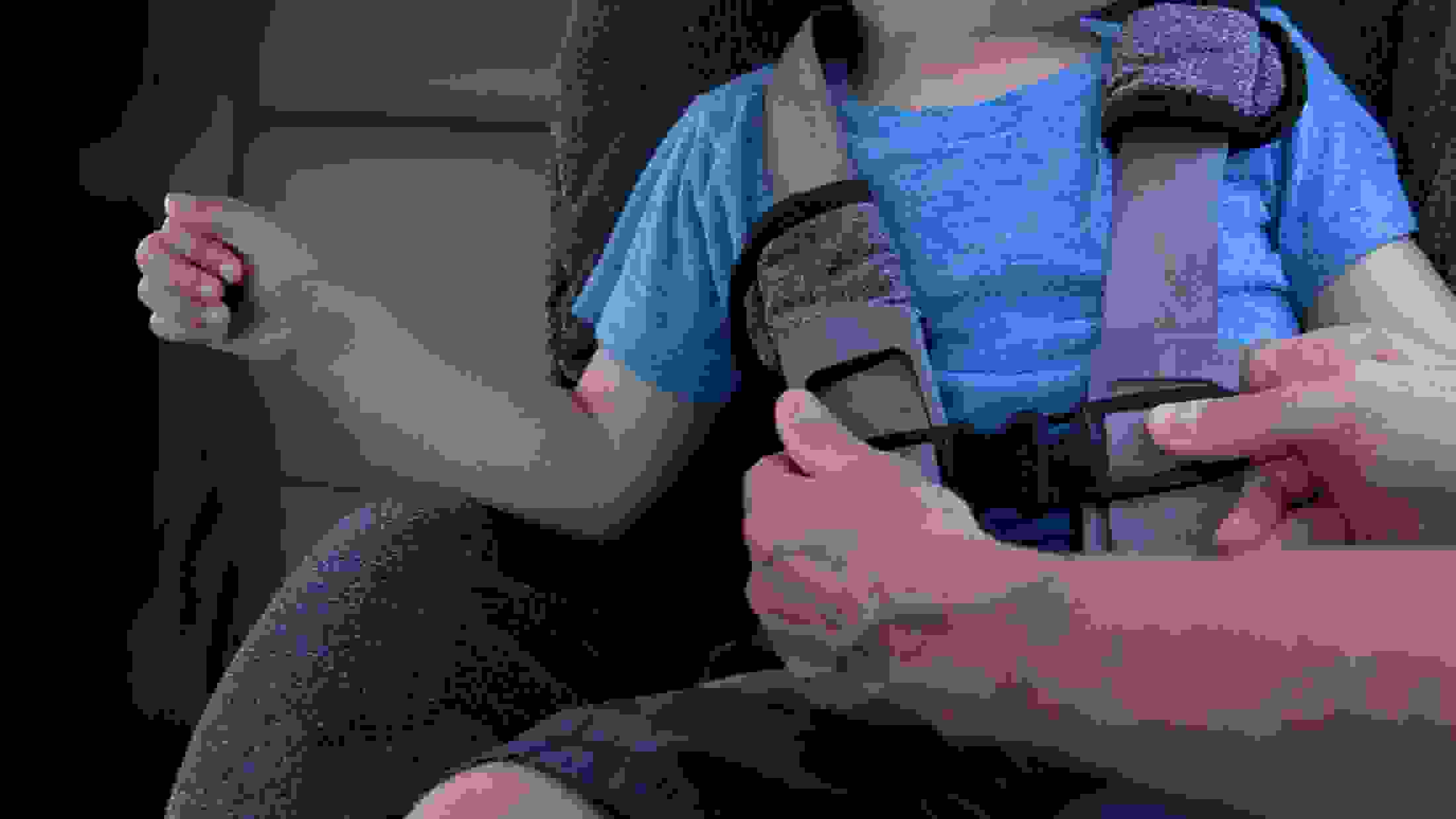 Toddler being strapped into his car seat