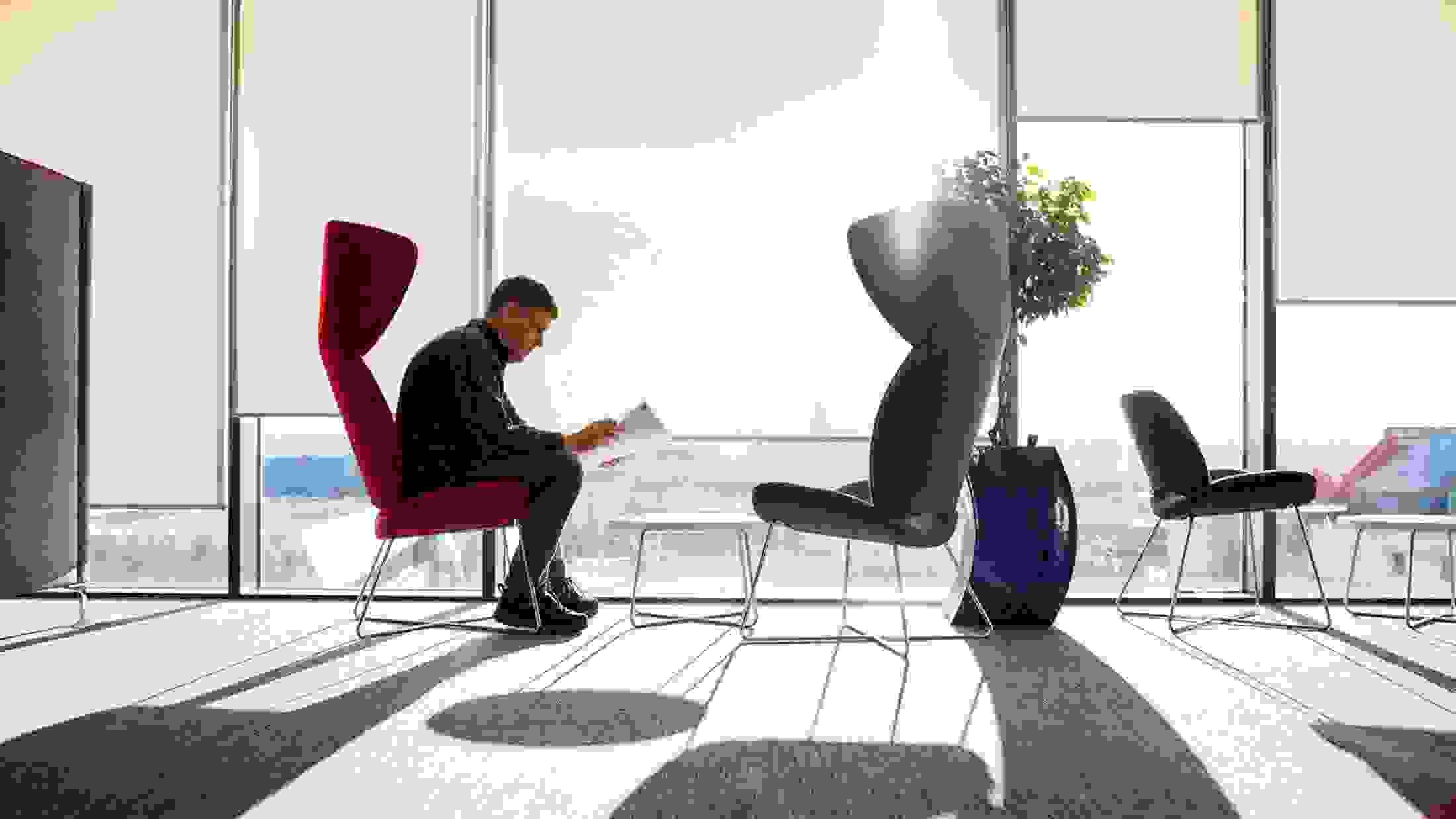 A businessman reads a report in a window seat