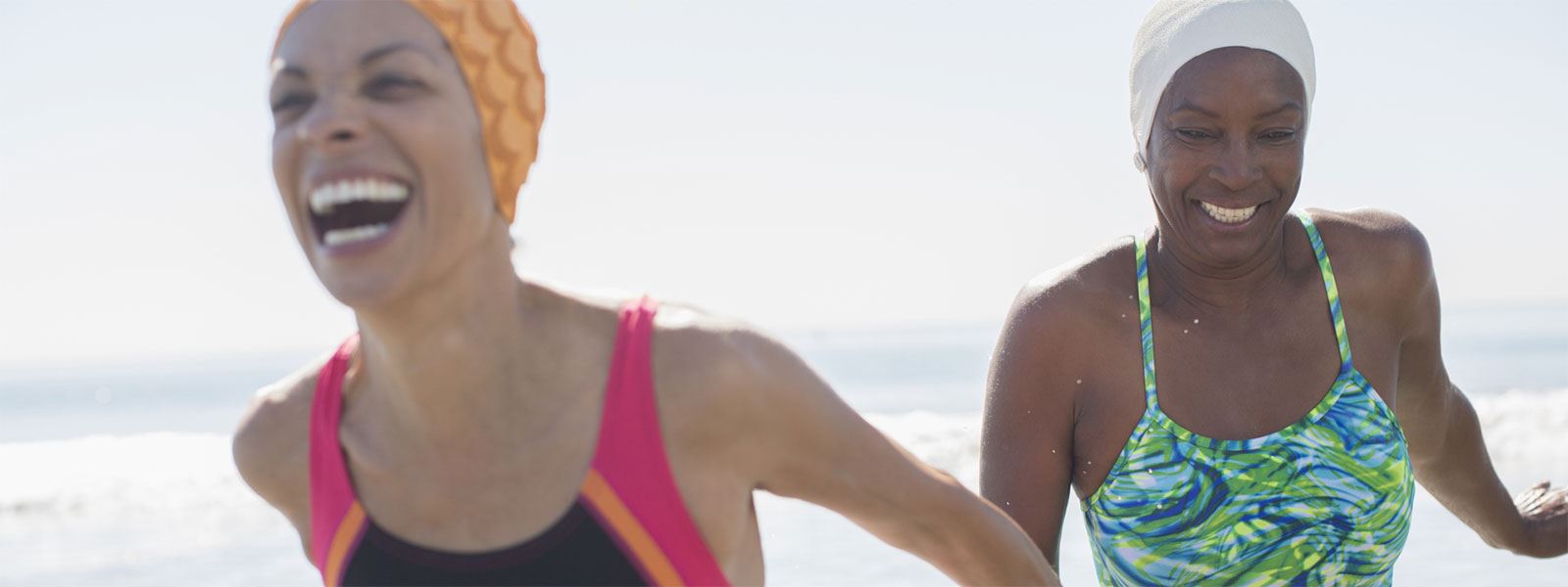Two women swimming on a beach