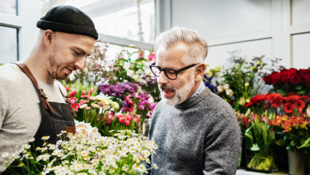 A male florist working on a flower arrangement