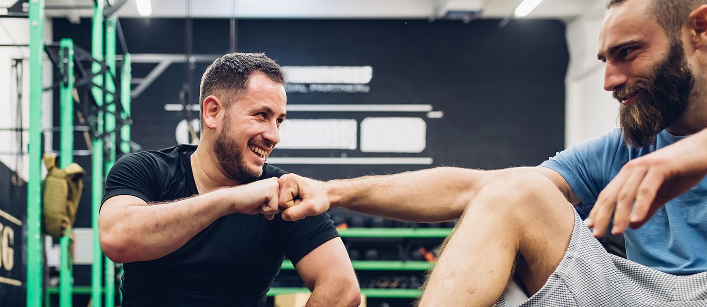 a personal trainer supporting their client