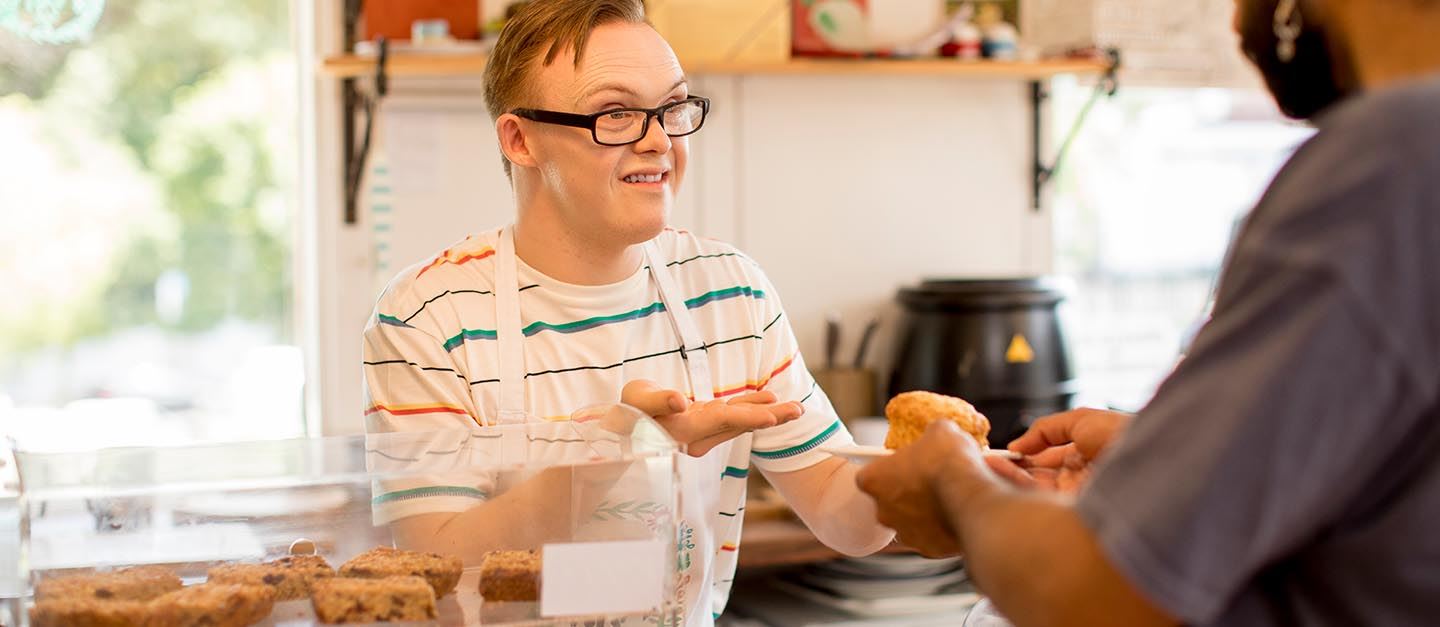 A person with down syndrome working as a cashier