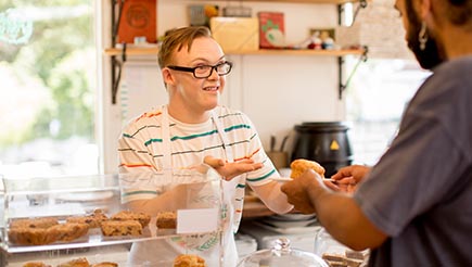 A person with Down Syndrome working in a bakery