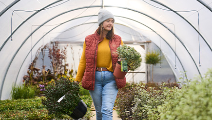 Gardener Bryony Mole at work, holding plants