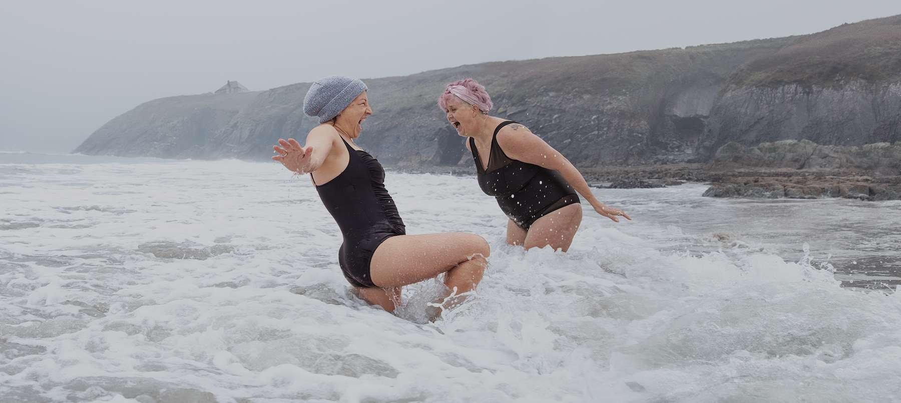 Two ladies from The Bluetits Open Water Swimmers in the sea off the Pemrokeshire coast