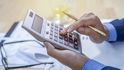 Someone calculating their business expenses.