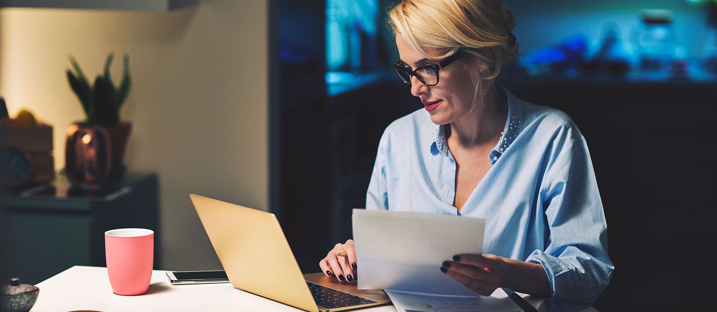 A woman sitting and sorting out financial paperwork