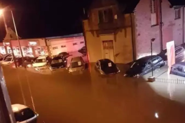 Parking lot of John Taylor Cars flooded with cars submerged