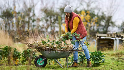 Bryony, a real AXA customer, working in a garden