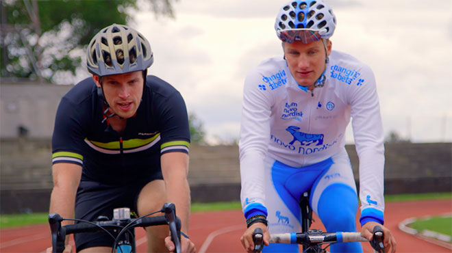 Two men cycling around a track