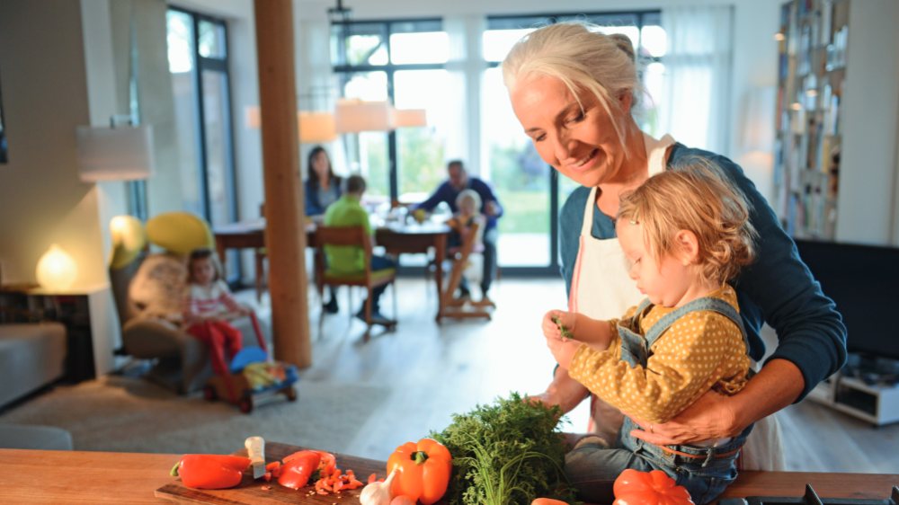 Grandmother preparing vegetables with her grandchild