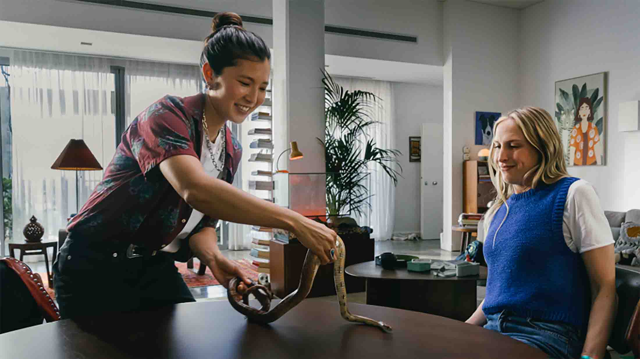 Sophie being presented with a snake after she told her school mum friend she was a vet