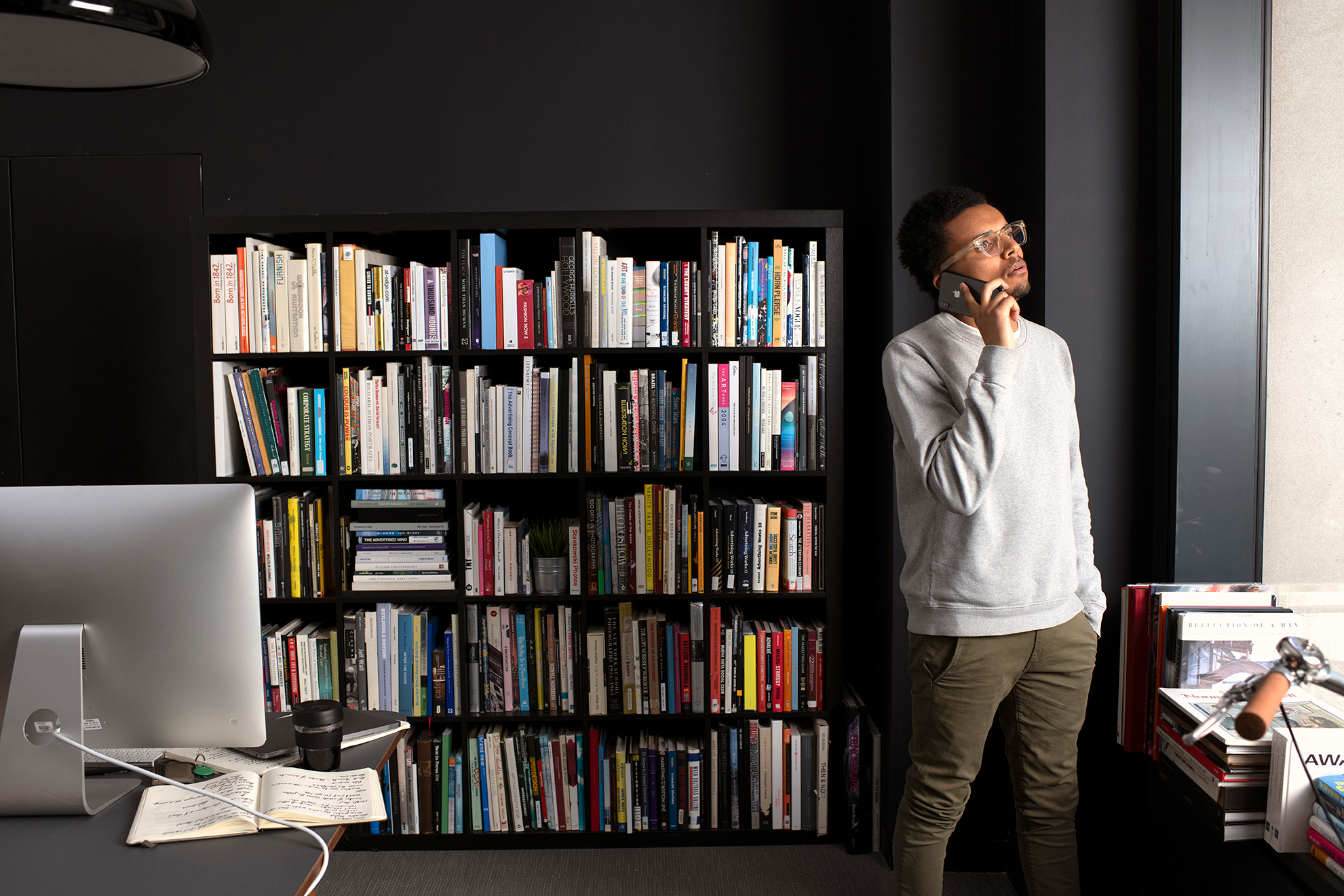 man standing in room looking out of window