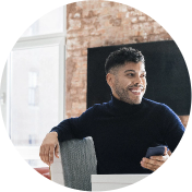 Man on his phone sitting at a table