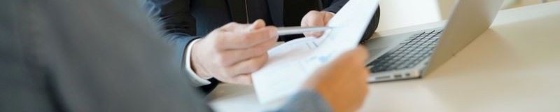 Two people signing a business contract