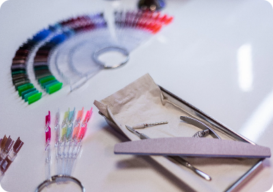 nail technician filing a clients nails