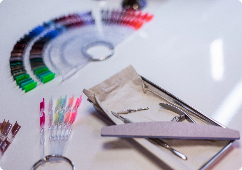 nail technician filing a clients nails