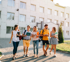 Five friendly students walking on campus