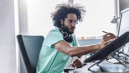A graphic designer working in his office