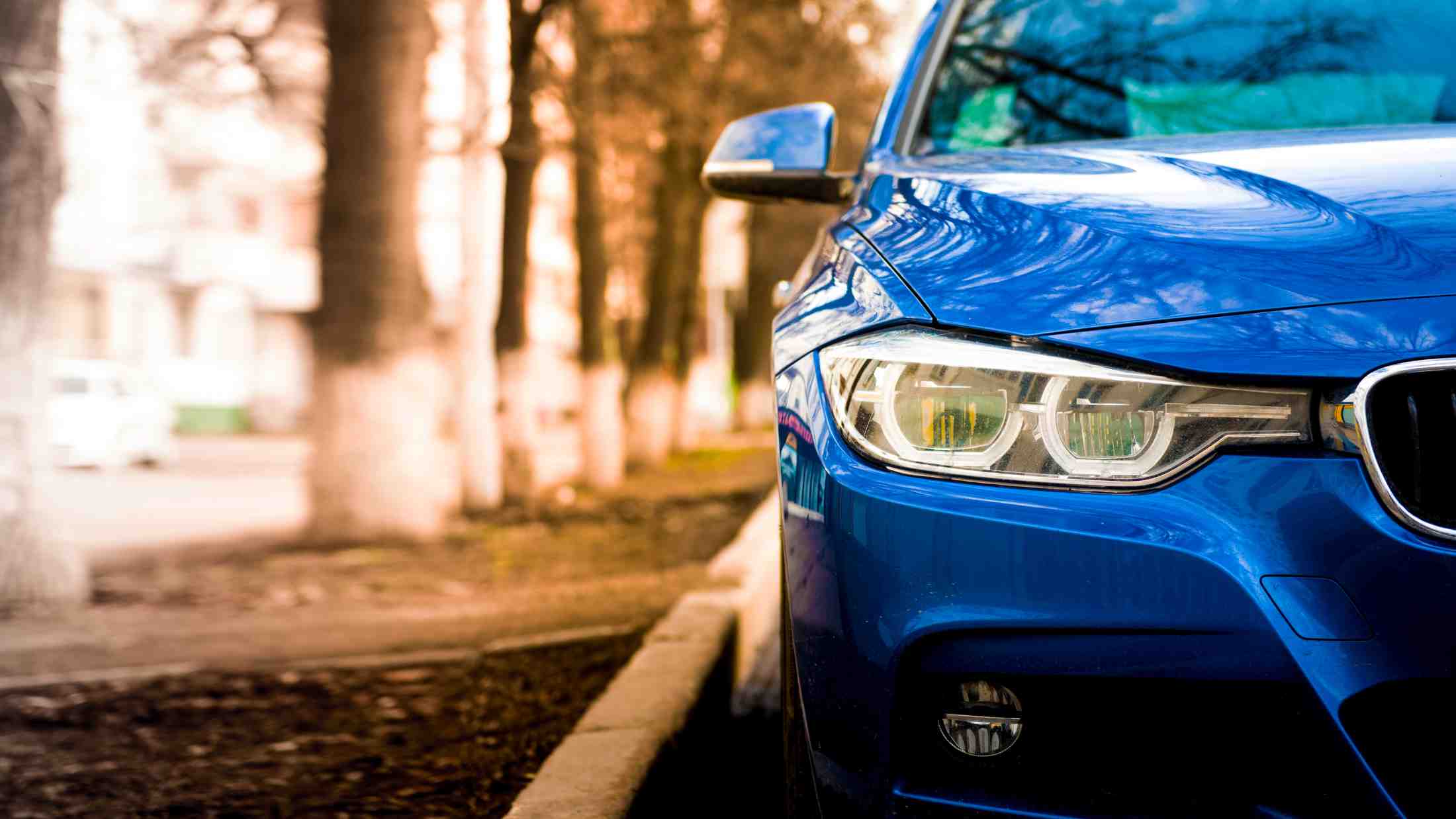 Blue BMW parked on roadside