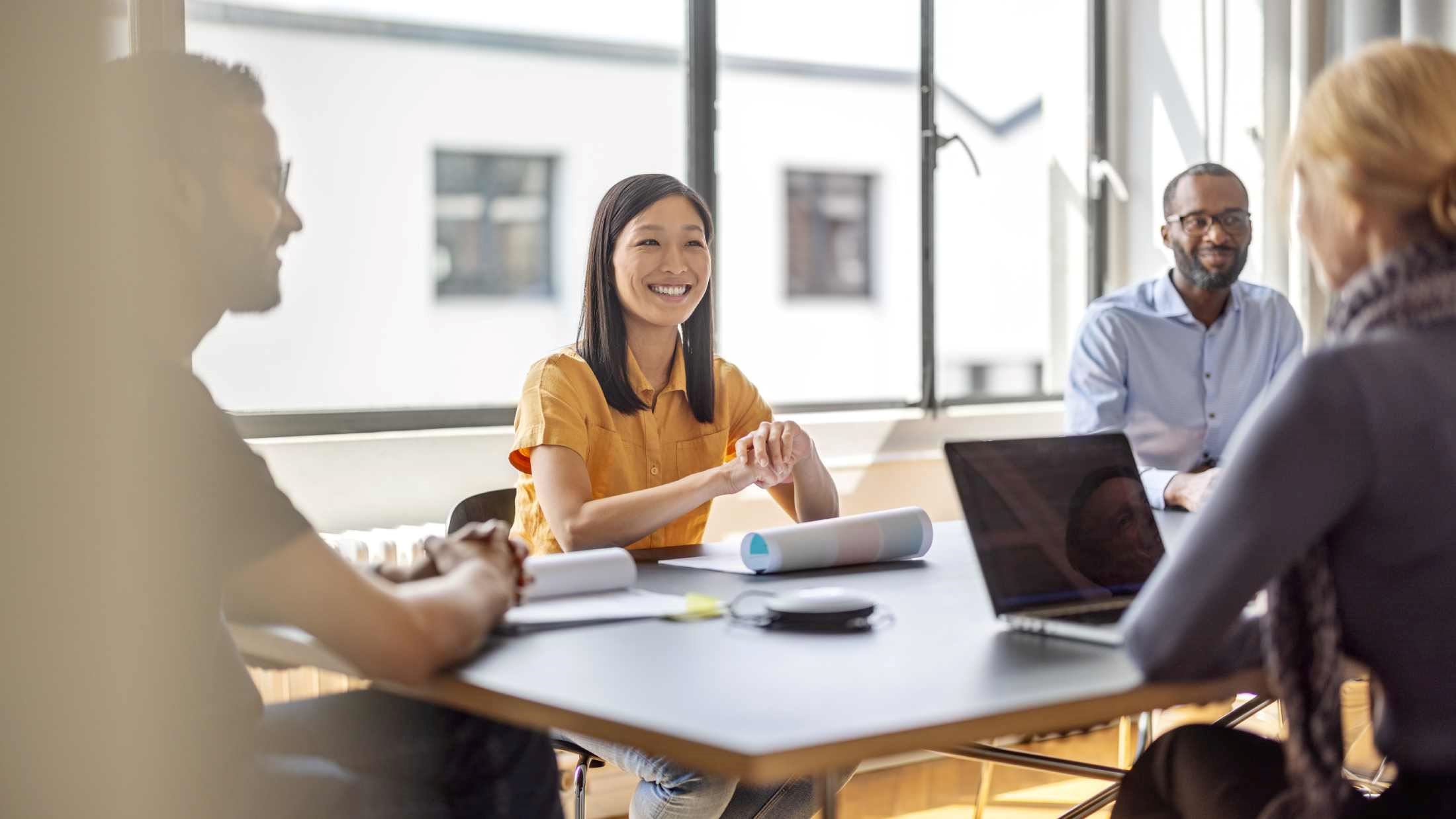Business team discussing strategies at a conference table in a corporate office boardroom