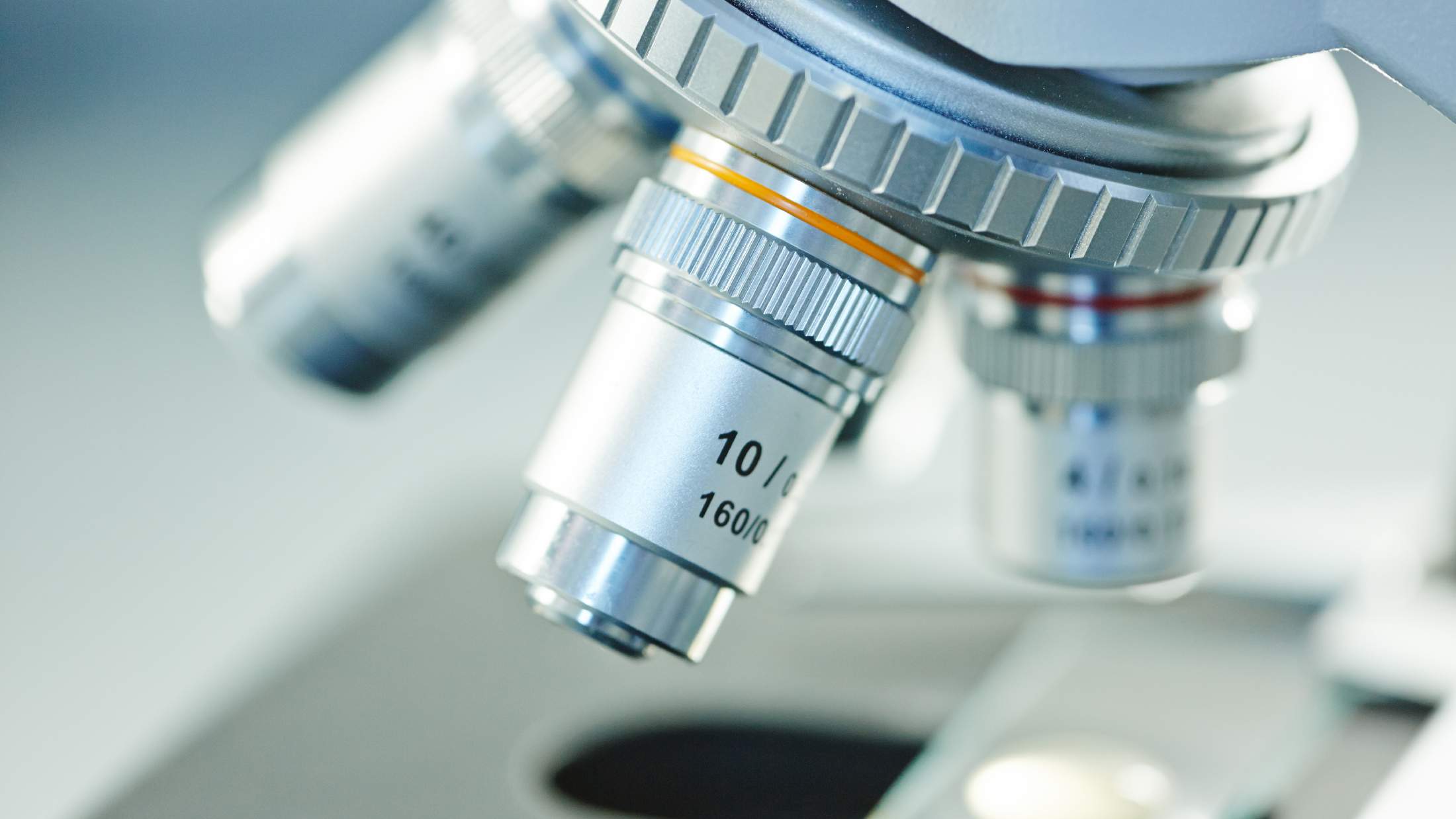 Closeup of microscope lenses in a laboratory