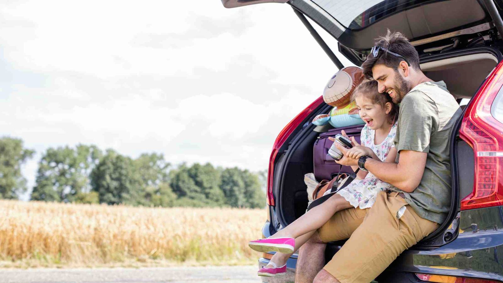 man and his daughter on the road to vacation