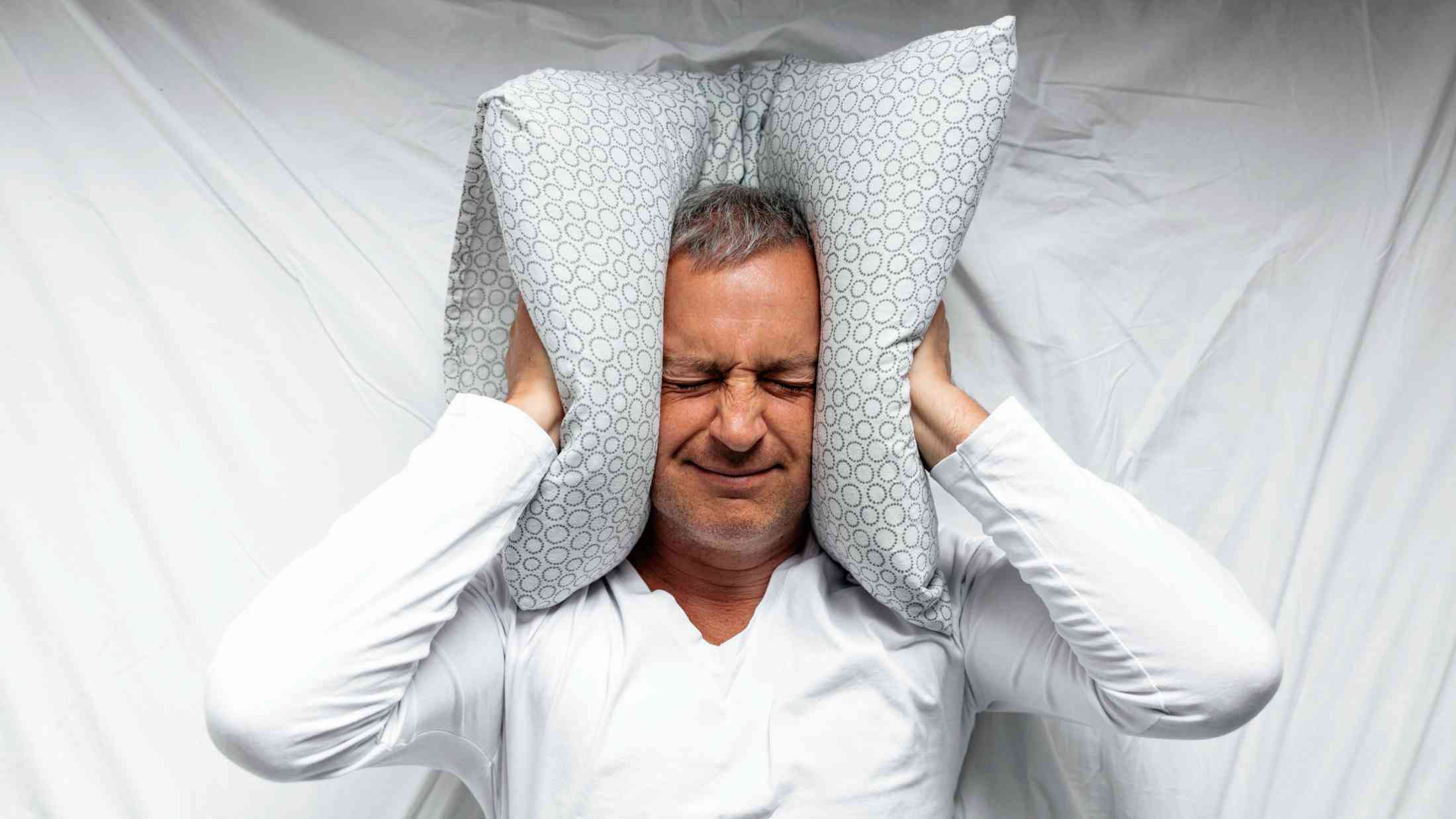 Mature man feeling uncomfortable in bed