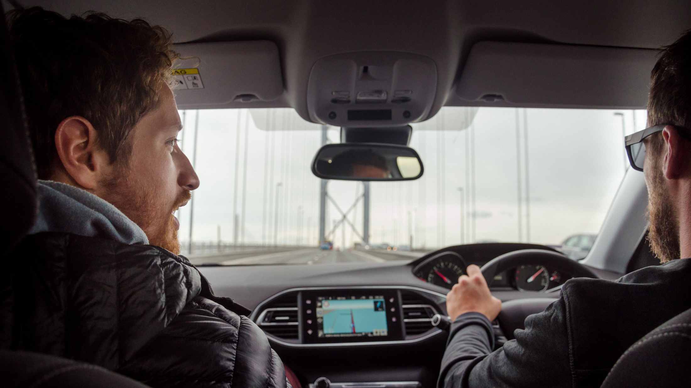 Rear view of a man driving with a co-driver