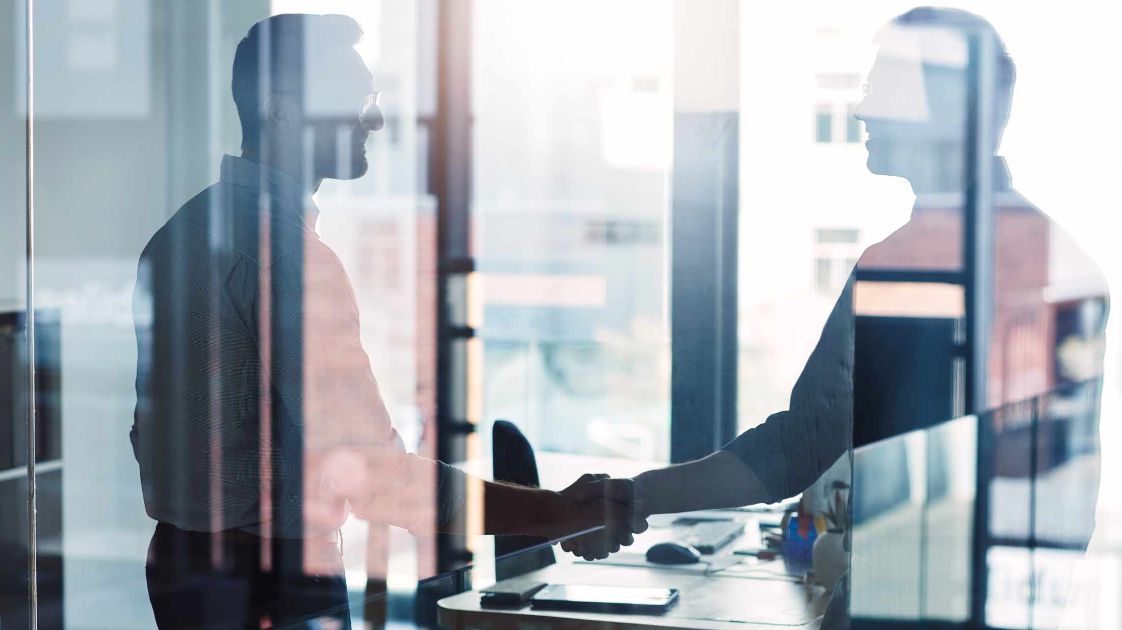 Two businessmen shaking hands in an office