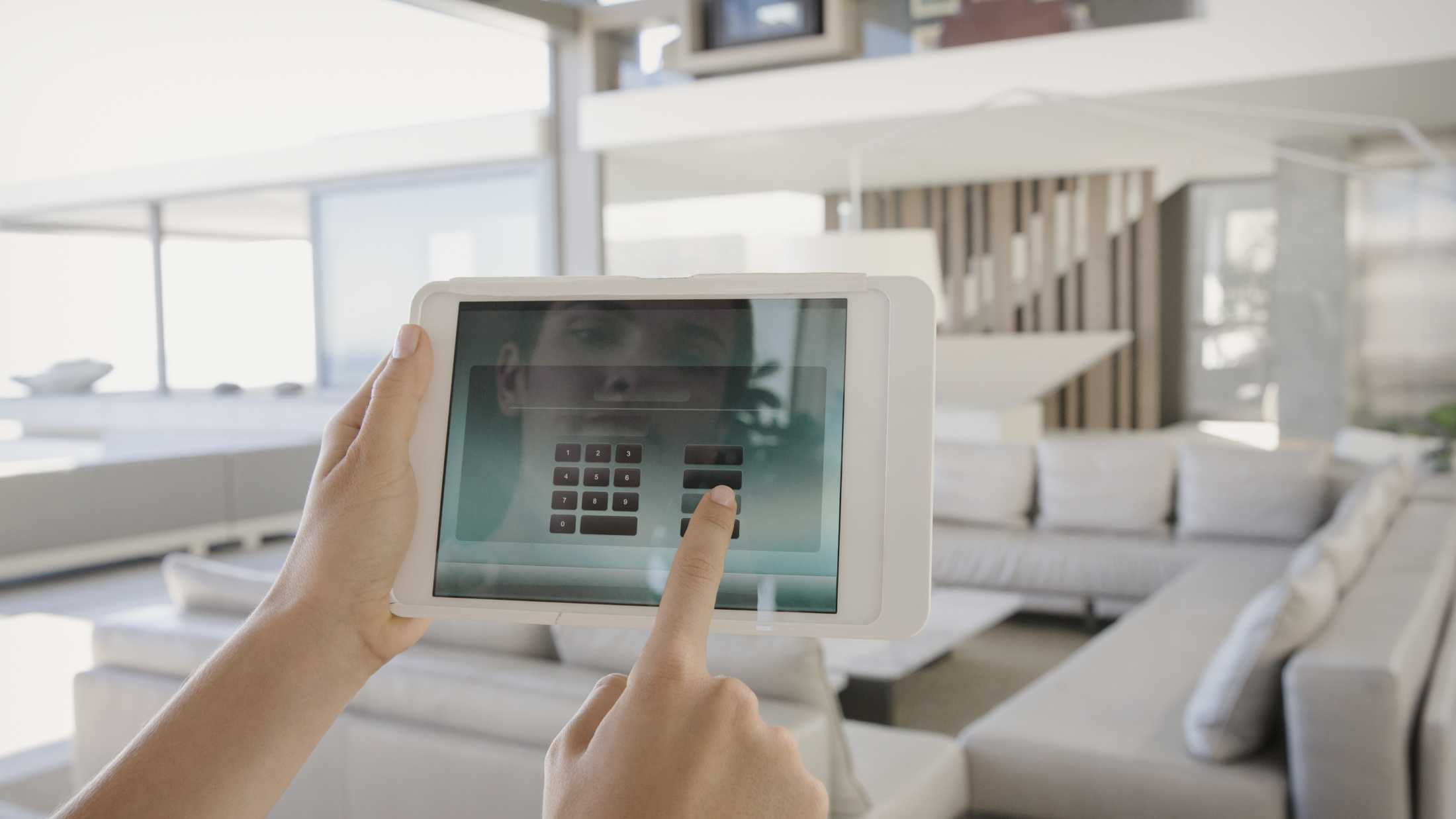 Woman entering password in to pin pad displayed on her tablet smart home automation device