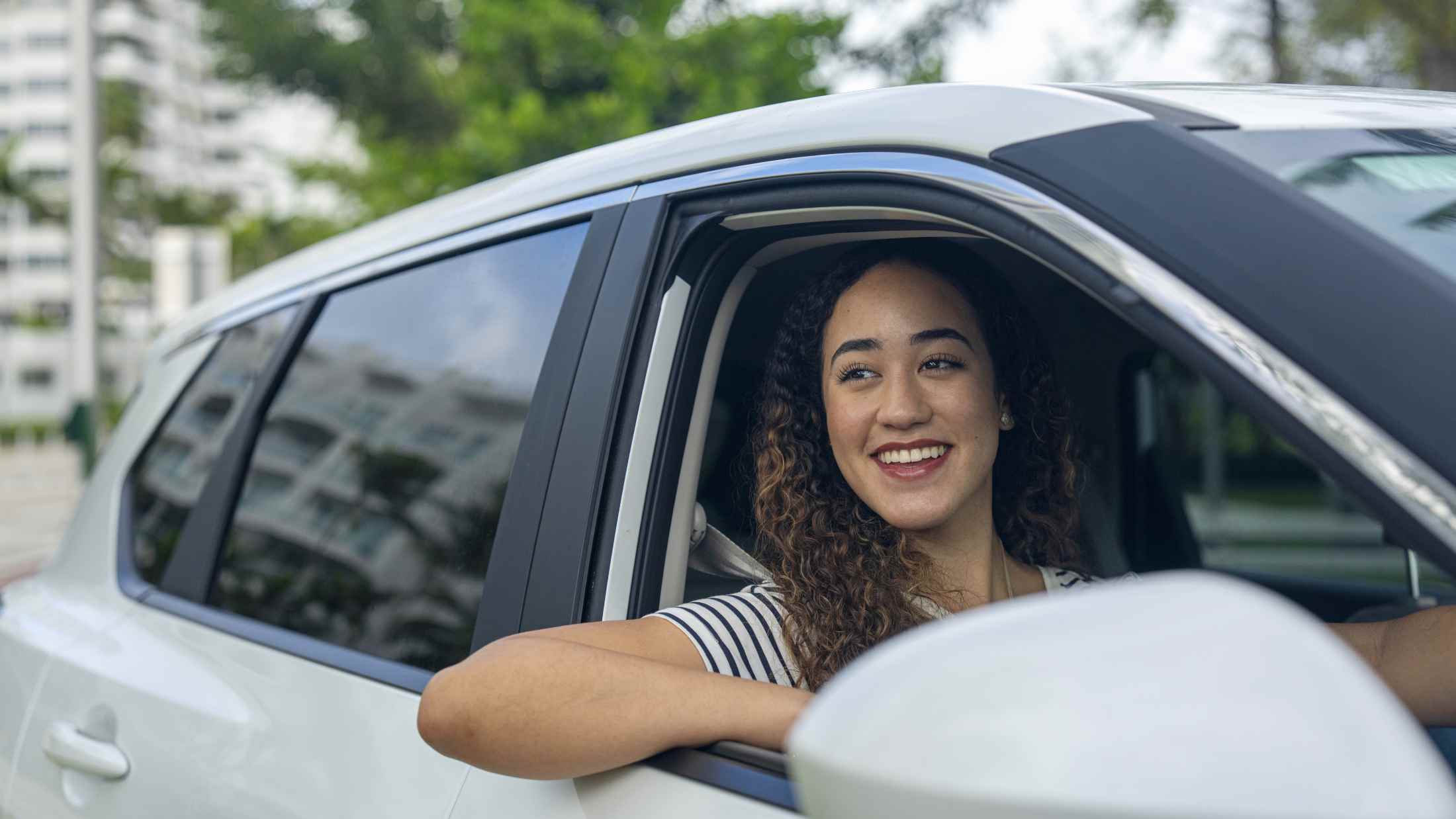 Woman looking at sights from her car while driving around with her family