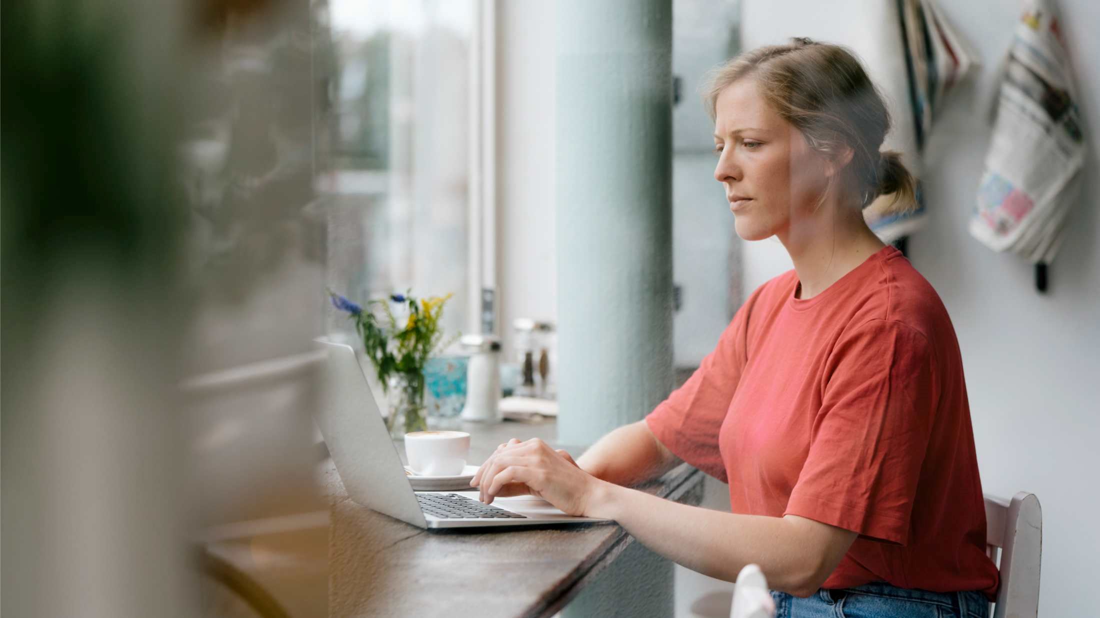 Woman using laptop in a cafe