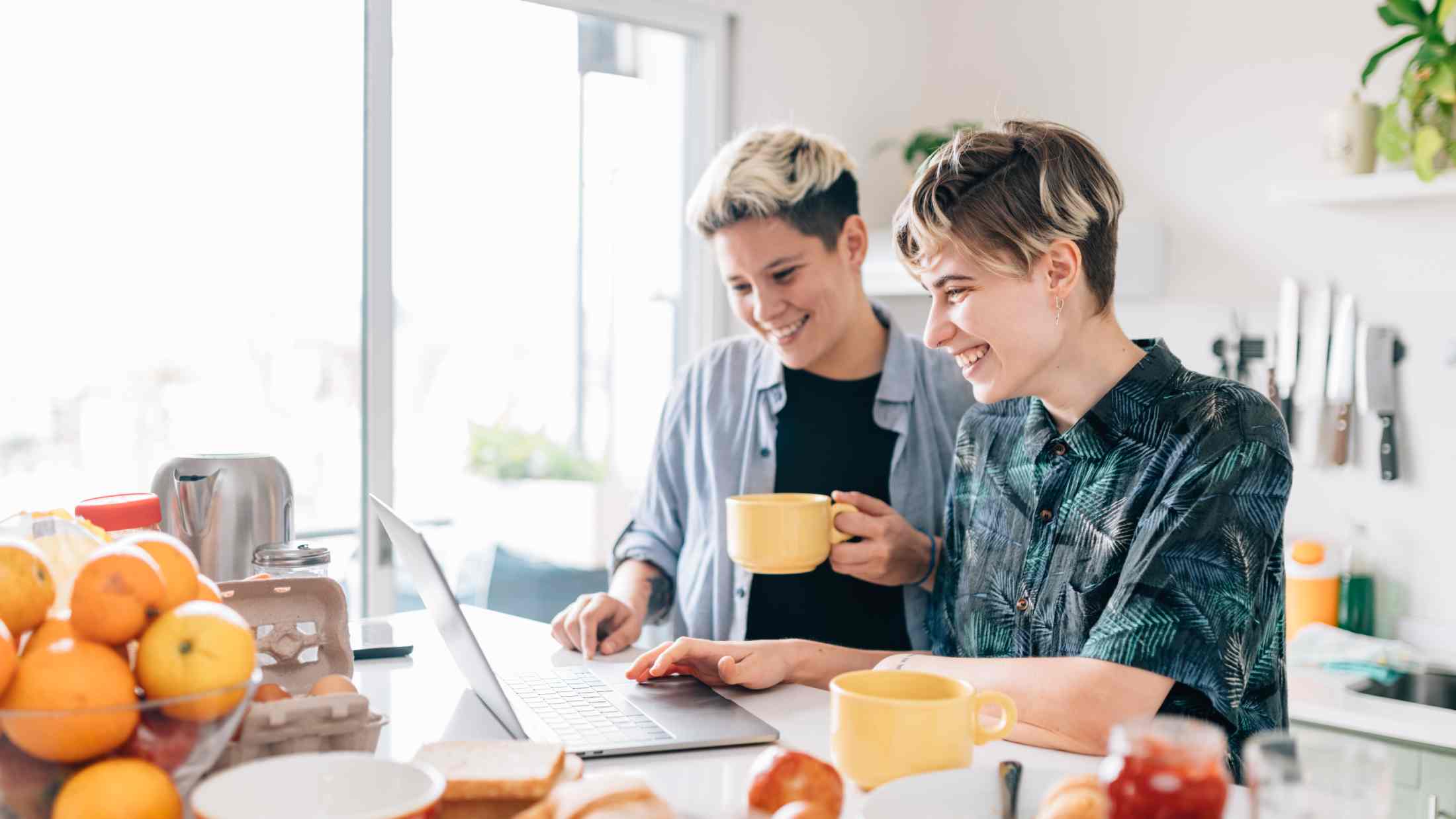 Women making plans on laptop during breakfast