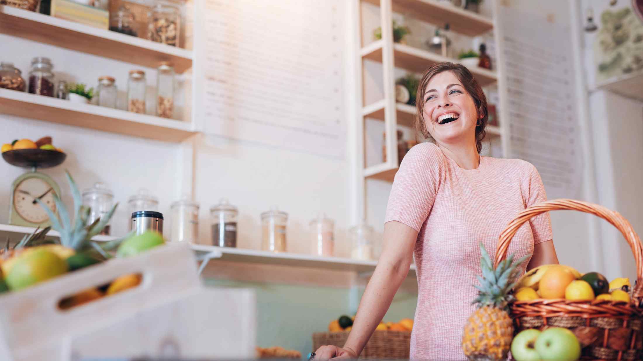 Young woman standing at a juice bar counter