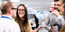 Image of group of people speaking in an office
