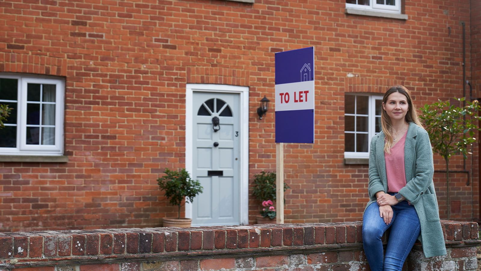 Andreea standing in front of one of her properties