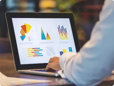 Man working on graphs on his laptop