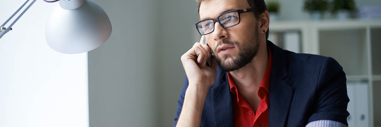A man talking on phone in his room
