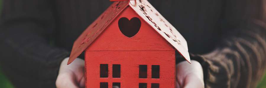 Toy wooden house with heart in roof