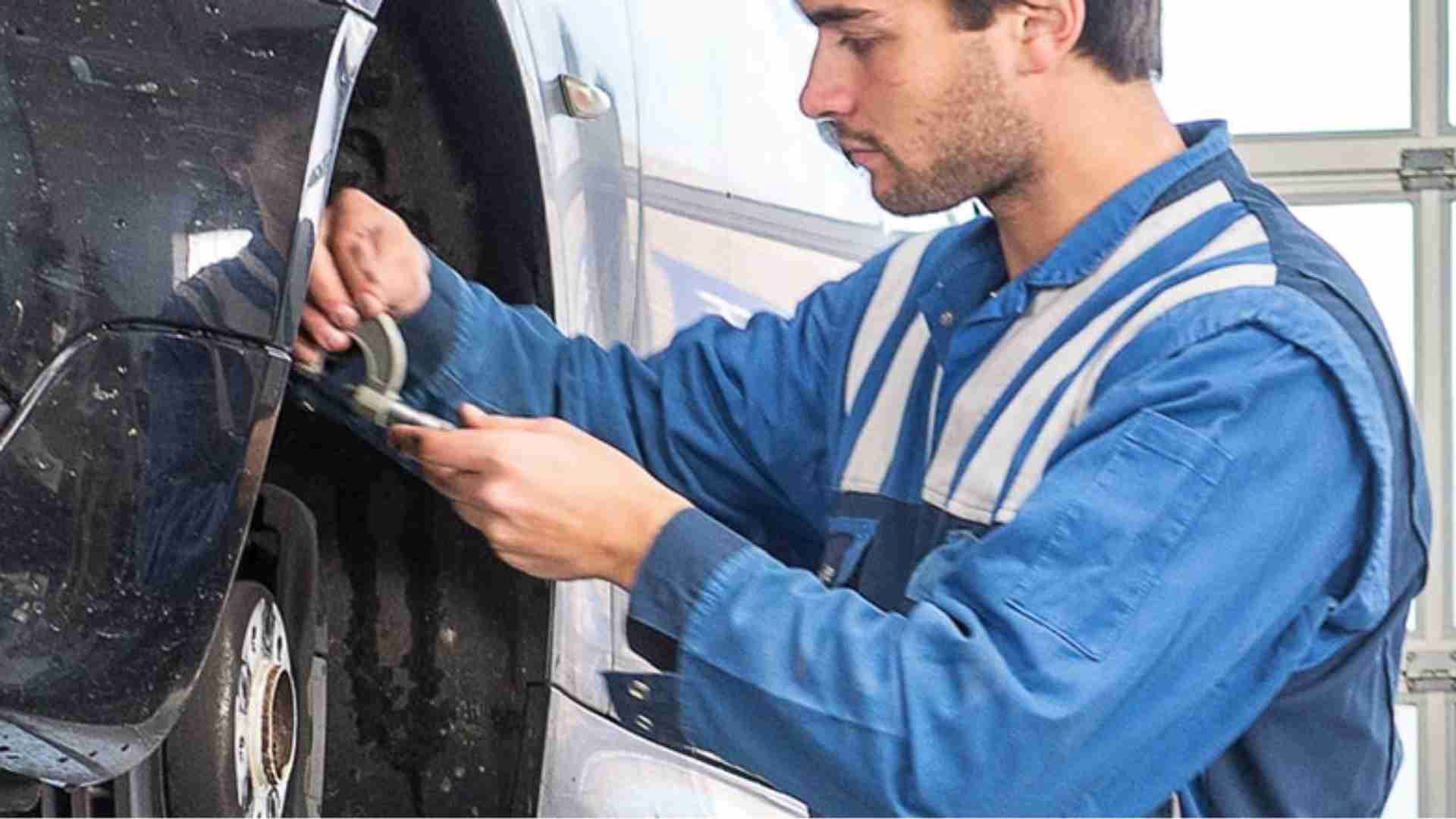 A mechanic working on a tyre