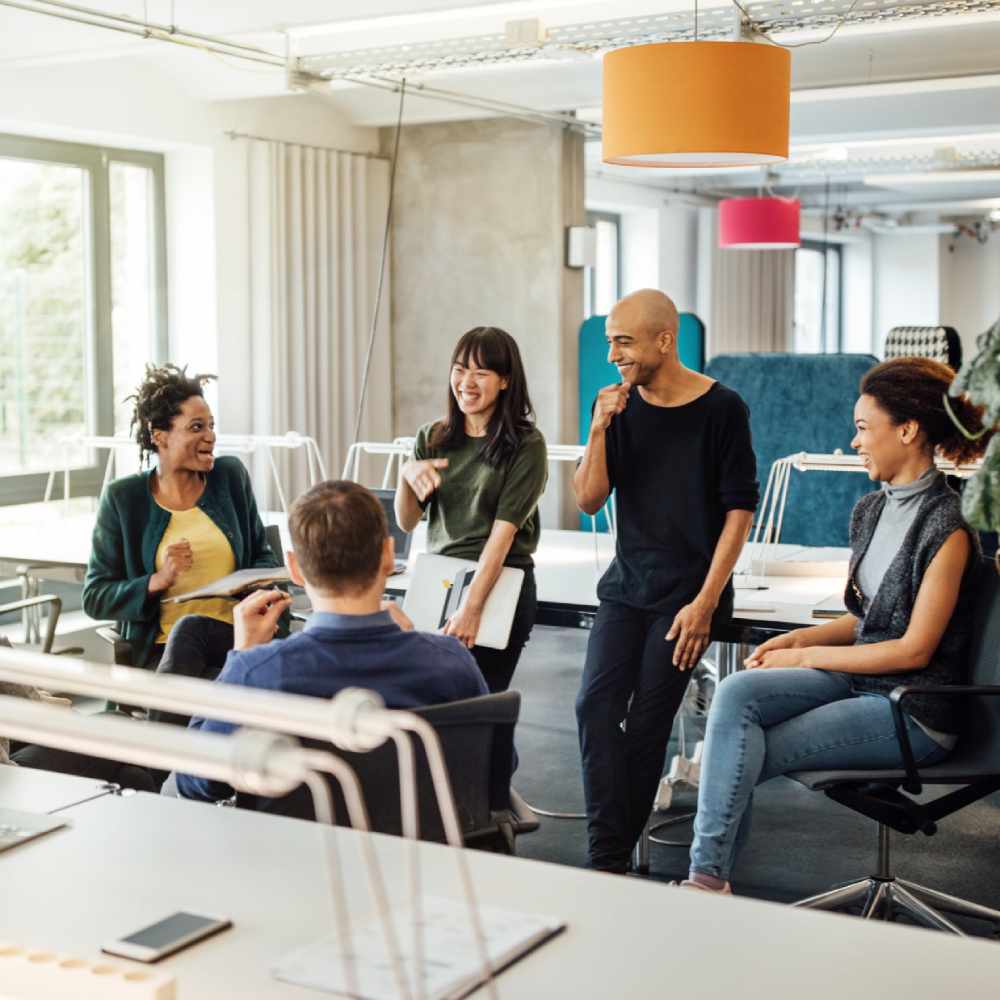 Happy multi-ethnic people discussing in meeting at creative office