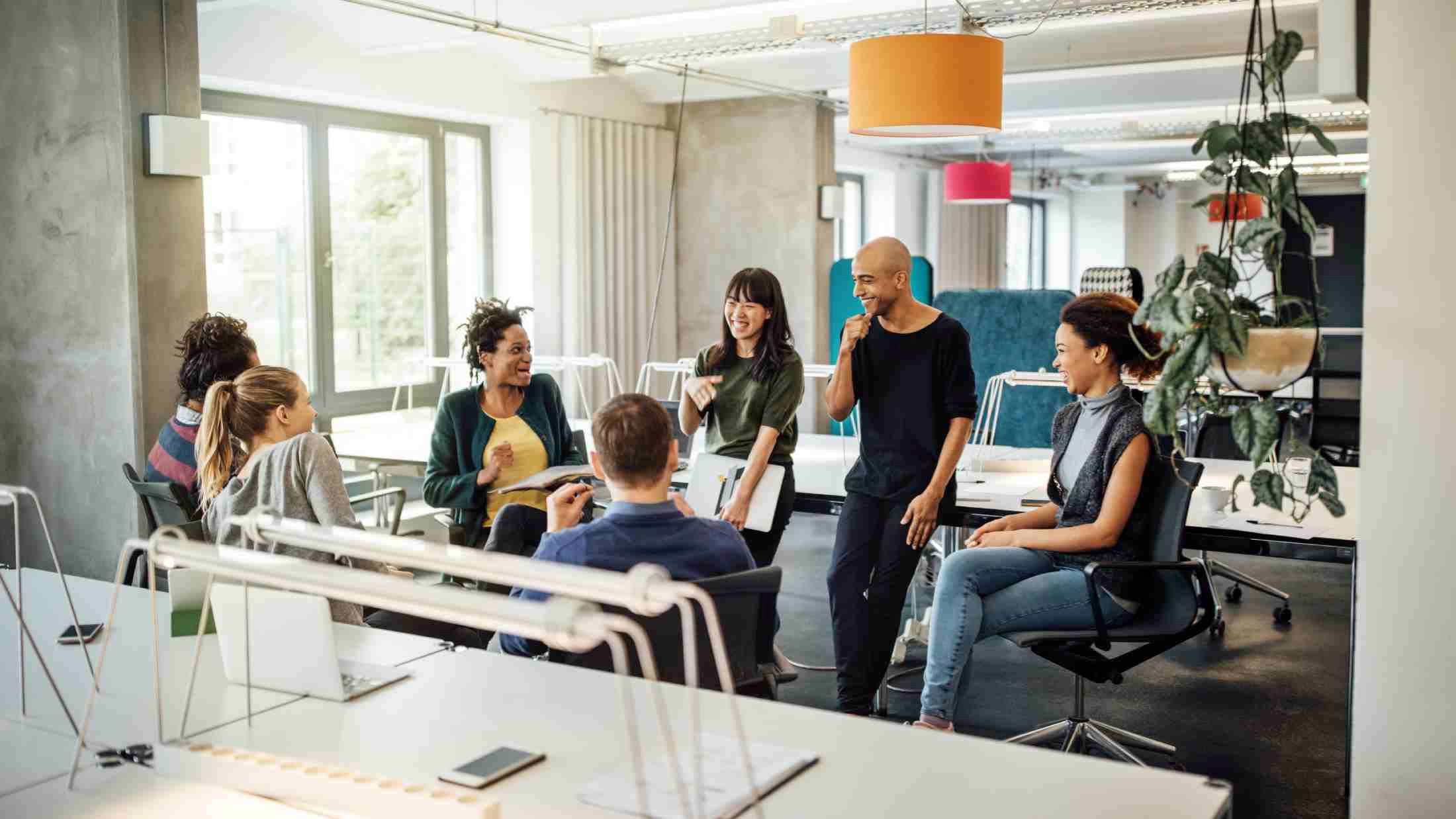 Happy multi-ethnic people discussing in meeting at creative office