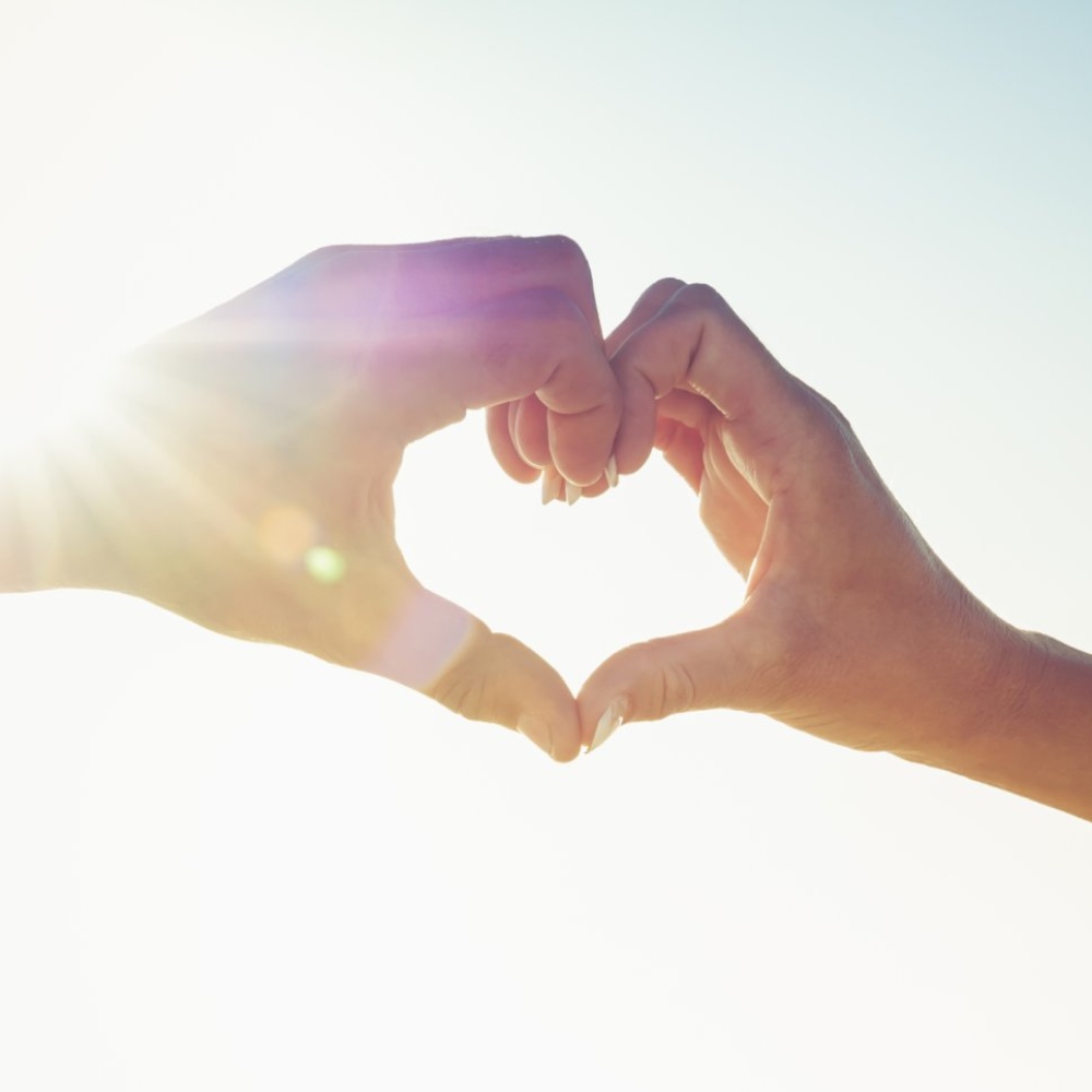 Two hands meeting to form a heart shape