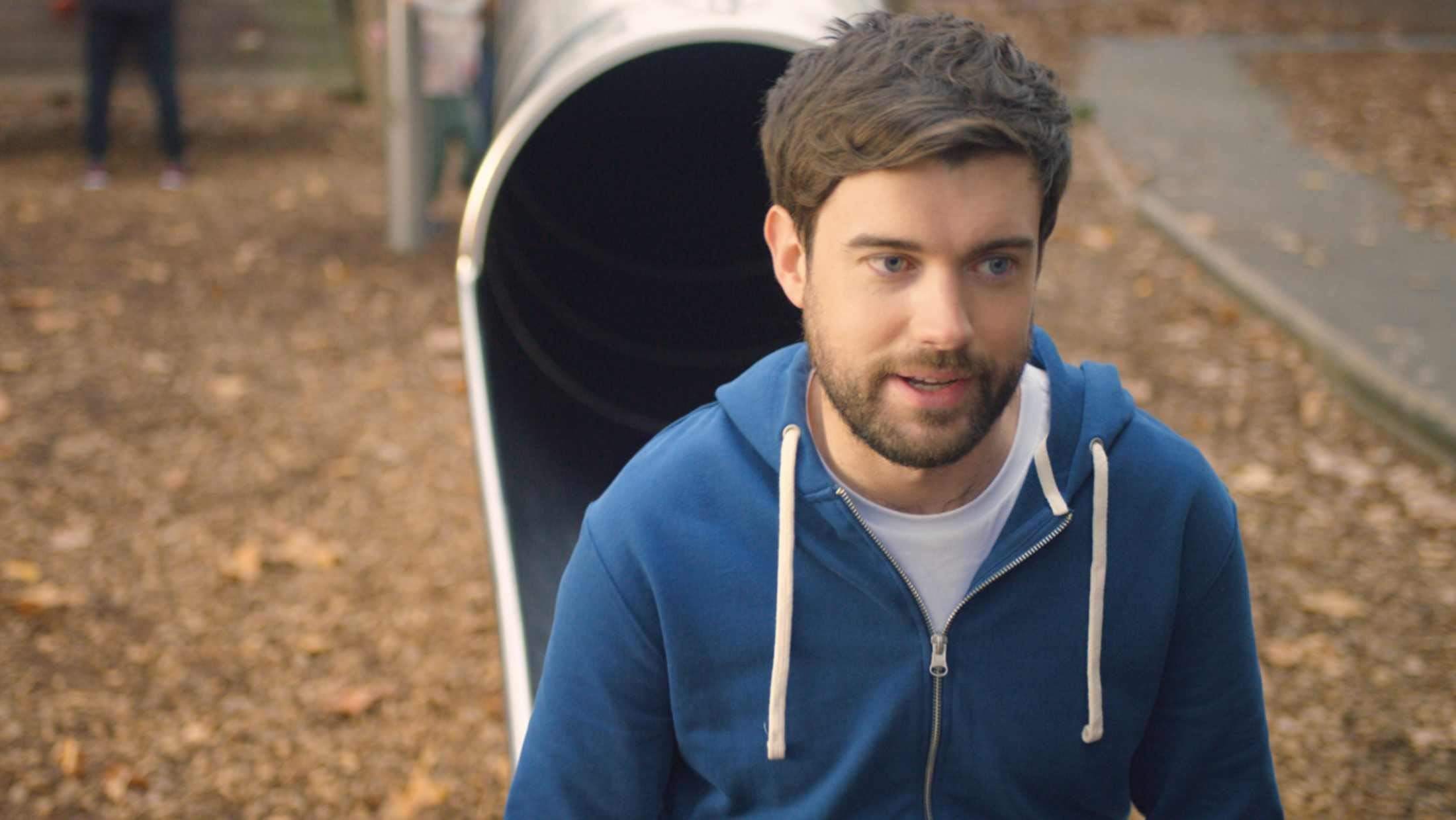 Jack Whitehall at the foot of a play slide